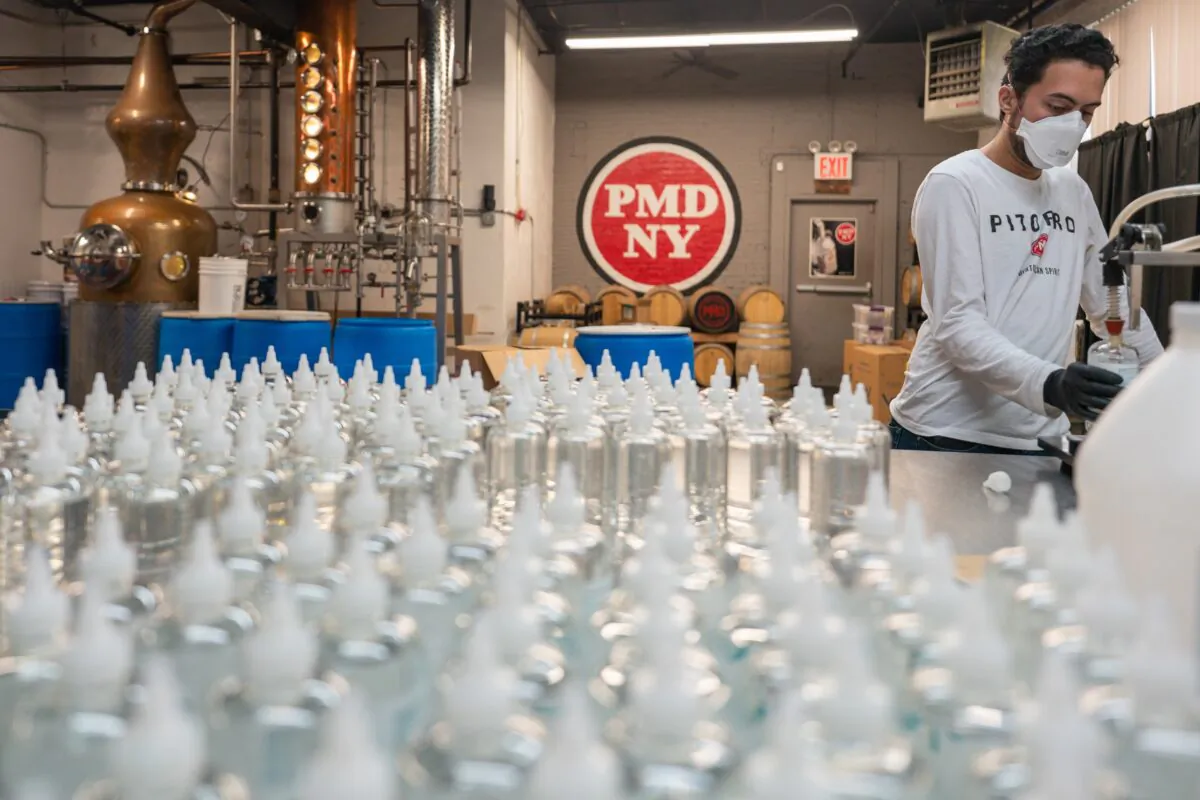 An employee fills a bottle with hand sanitizer at Port Morris Distiller in New York City on April 21, 2020. (David Dee Delgado/Getty Images)