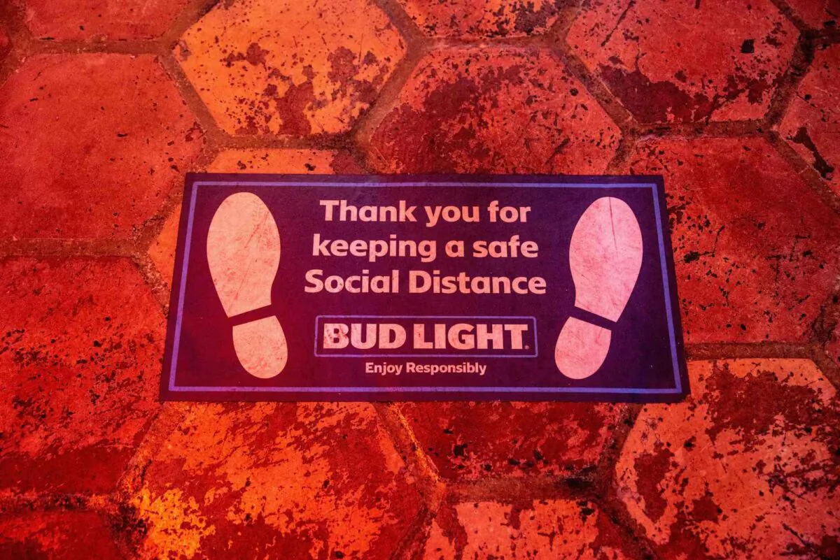 A sign encouraging social distancing is seen on the floor inside a bar in Austin, Tx., on June 26, 2020. (Sergio Flores/AFP via Getty Images)