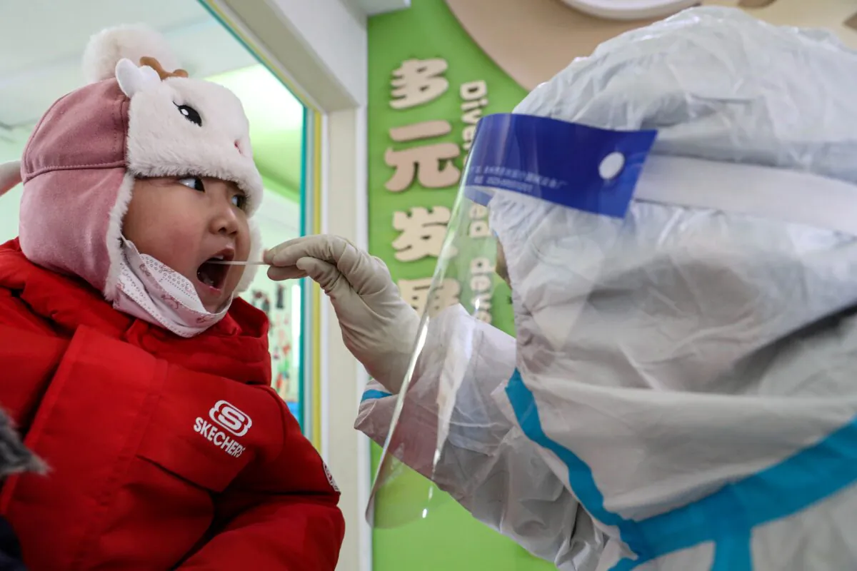 A child takes a COVID-19 swab test in Shenyang, China on Jan. 1, 2021. (STR/AFP via Getty Images)