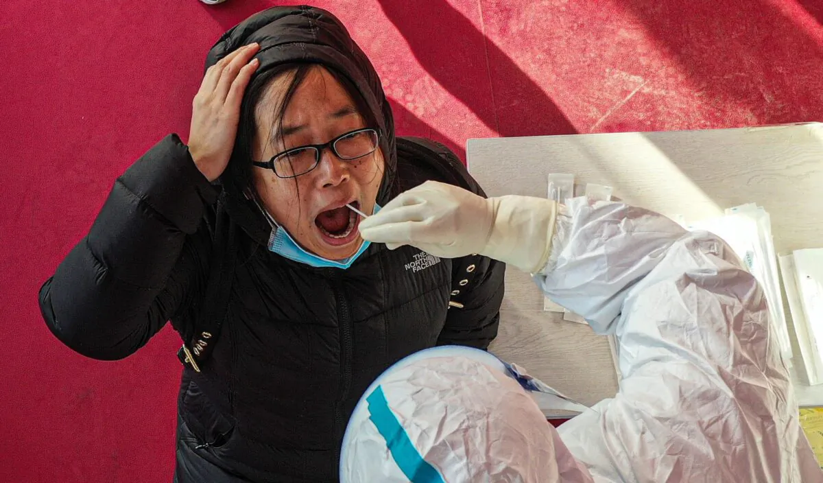 A health worker takes a swab sample from a resident for a COVID-19 test in Shenyang, China, on Jan. 2, 2021. (STR/AFP via Getty Images)