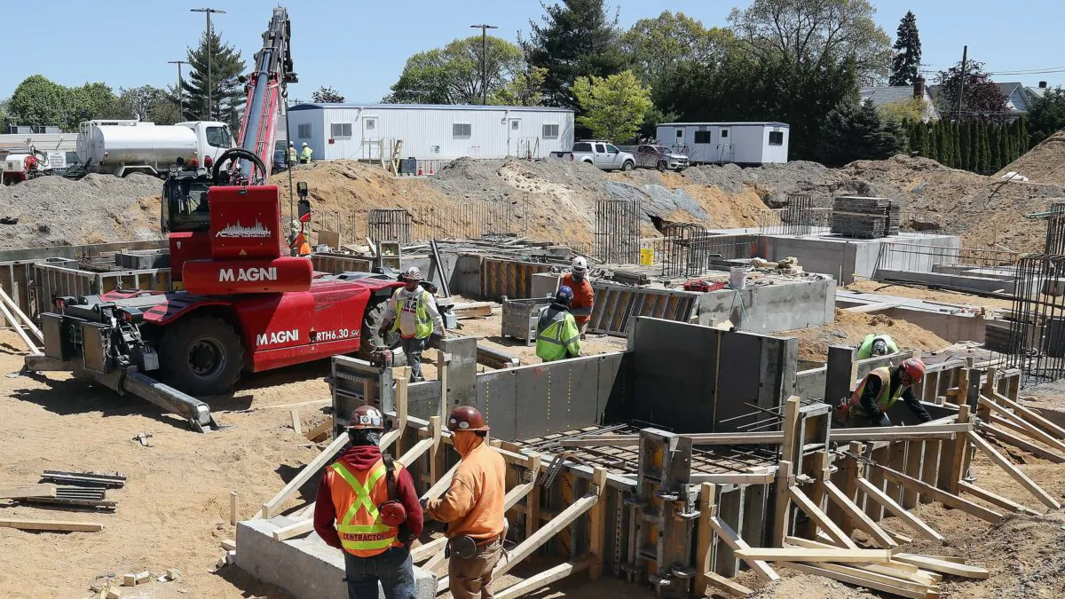 Construction workers perform their jobs in front of Mount Sinai South Nassau Hospital in Oceanside, N.Y., on May 13, 2020. (Bruce Bennett/Getty Images)