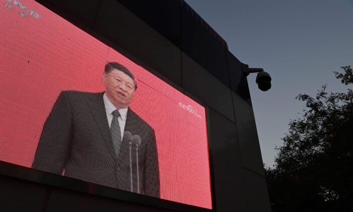 A video clip of Chinese Leader Xi Jinping is seen on the outside of a police patrol station in Beijing on Nov. 2, 2020. (Greg Baker/AFP via Getty Images)