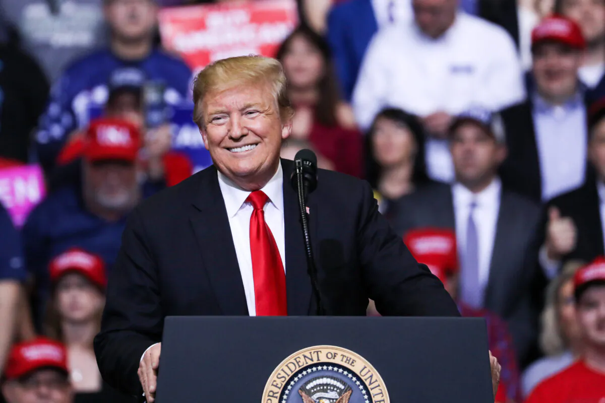 Then-President Donald Trump smiles at a MAGA rally in Grand Rapids, Mich., on March 28, 2019. (Charlotte Cuthbertson/The Epoch Times)