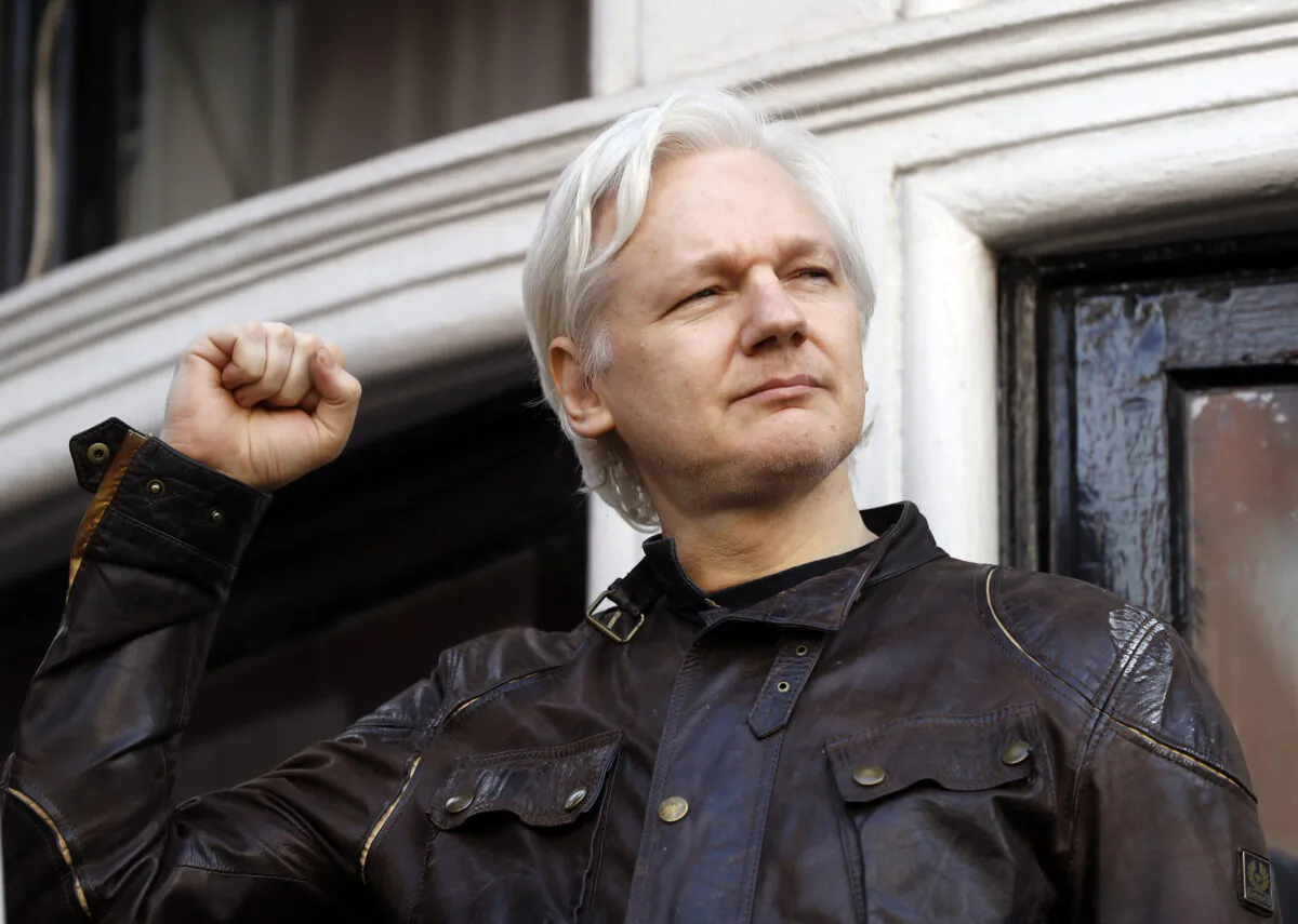 WikiLeaks founder Julian Assange greets supporters outside the Ecuadorian embassy in London on May 19, 2017. (Frank Augstein/AP Photo)