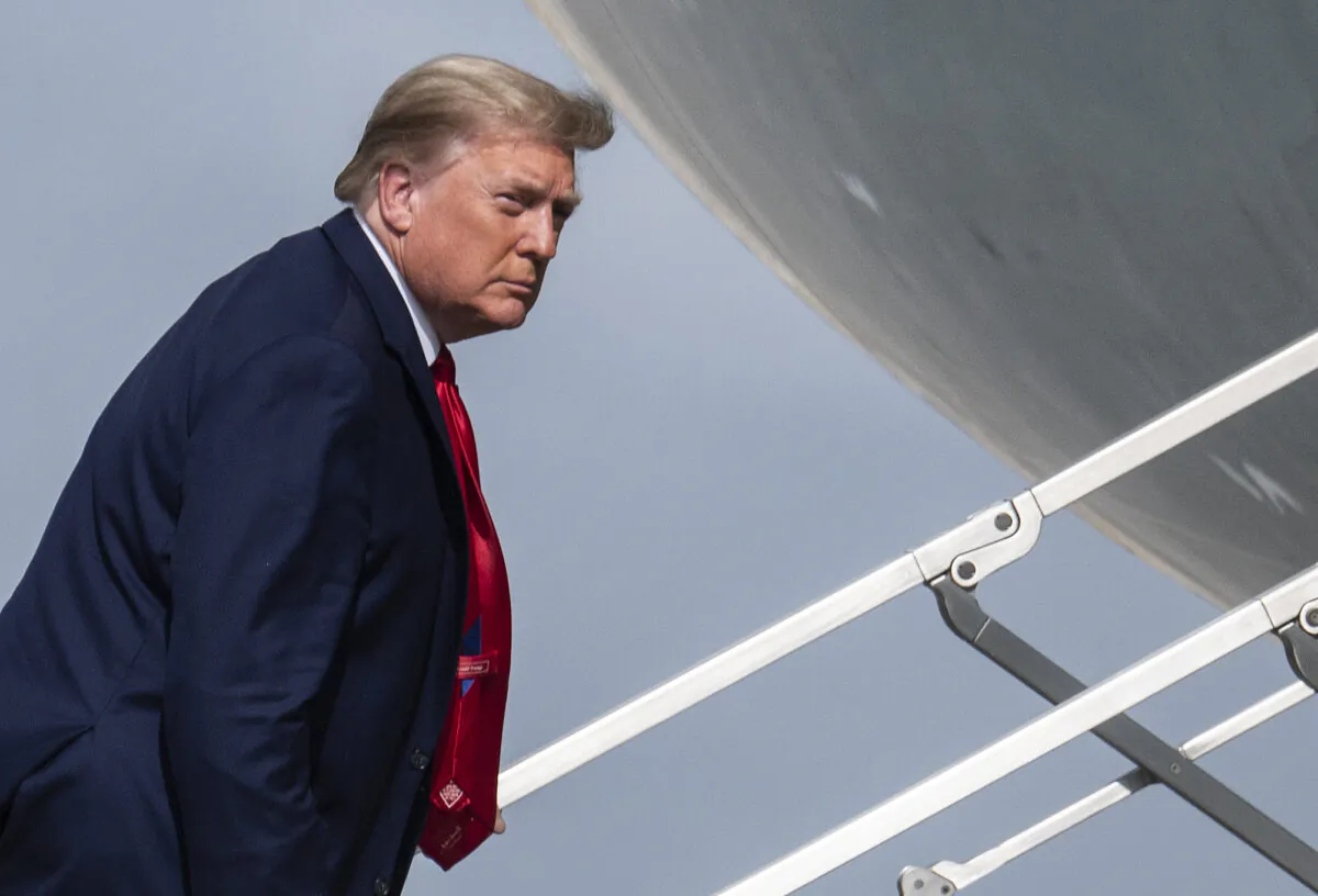 President Donald Trump boards Air Force One while departing from Palm Beach International Airport in West Palm Beach, Fla., on Dec. 31, 2020. (Andrew Caballero-Reynolds/AFP via Getty Images)