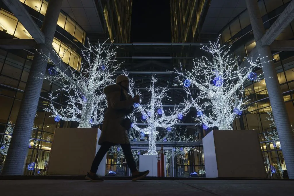A pedestrian walks by Christmas decorations during the holidays in Montreal on Dec. 18, 2020.
(Mario Beauregard/The Canadian Press)