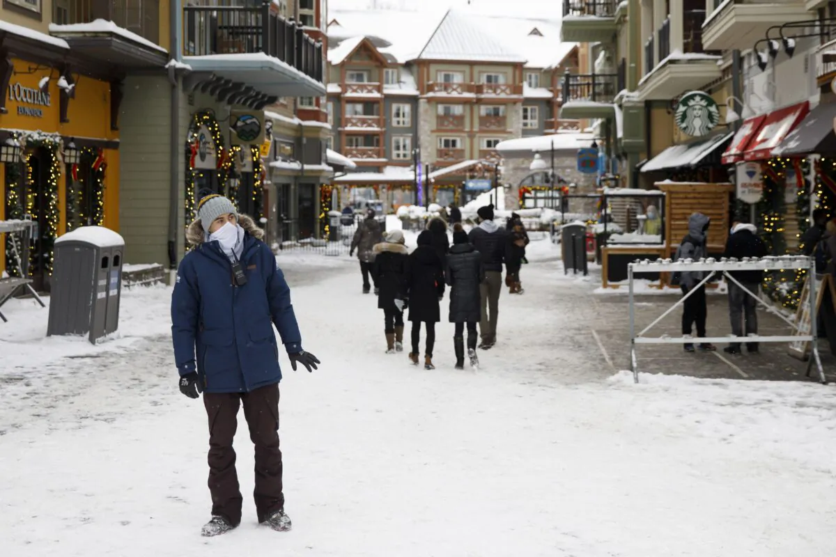 An employee waits to inform guests of the closure of the village at Blue Mountain Resort in the Blue Mountains, Ont., on Dec. 26, 2020, the first day of the provincewide lockdown. (The Canadian Press/Cole Burston)