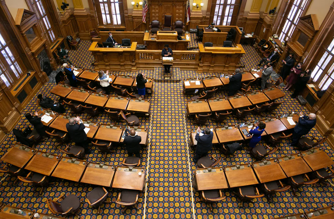 Georgia Democratic Electors stand and clap after casting their Electoral College votes at the Georgia State Capitol on Dec. 14, 2020 in Atlanta, Georgia.  (Jessica McGowan/Getty Images)
