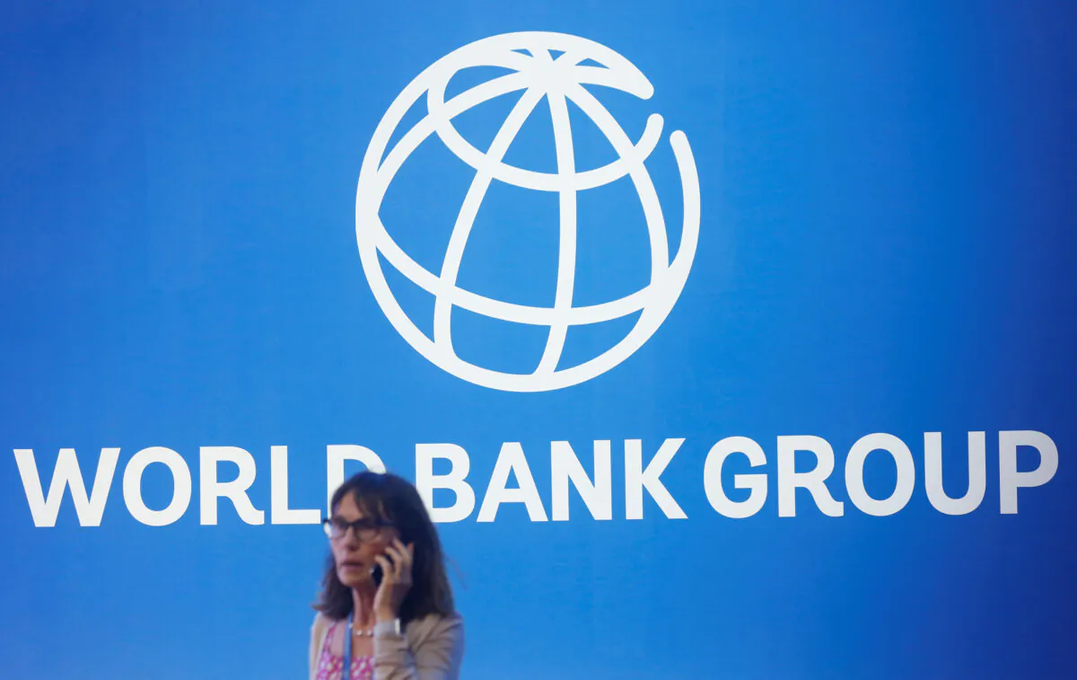 A participant stands near a logo of World Bank at the International World Bank Annual Meeting in Nusa Dua, Bali, Indonesia, on Oct. 12, 2018. (Johannes P. Christo/Reuters)