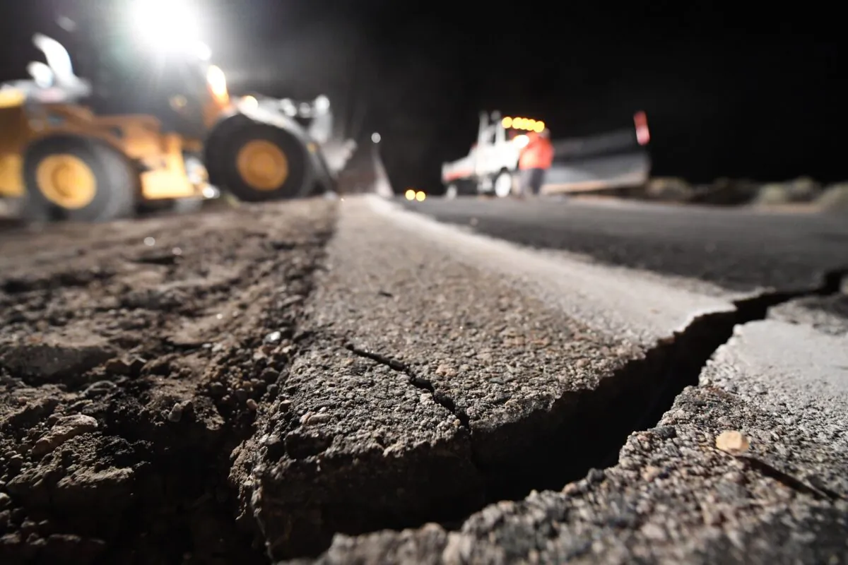 Highway workers repair a hole that opened in the road as a result of the July 5, 2019 earthquake, in Ridgecrest, California, about 150 miles (241km) north of Los Angeles, early in the morning on July 6, 2019. (Robyn Beck/AFP via Getty Images)