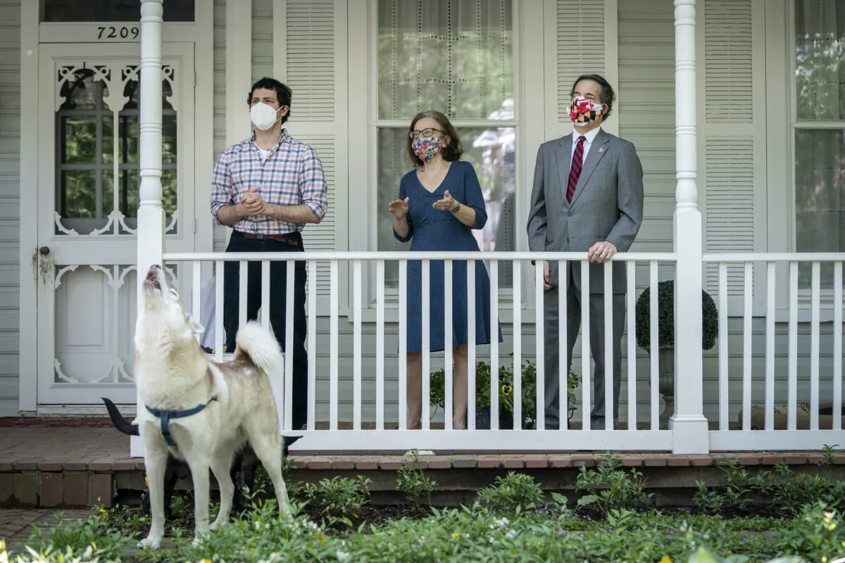 Thomas Raskin, left, is seen with his parents, Sarah Bloom Raskin and Rep. Jamie Raskin (D-Md.) in Washington on May 4, 2020. (Drew Angerer/Getty Images)