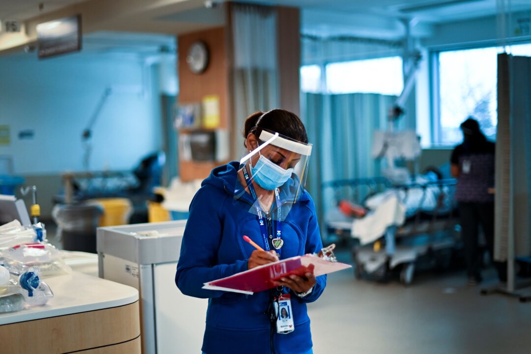 A health-care worker conducts an audit at the Humber River Hospital in Toronto on Dec. 9, 2020. (The Canadian Press/Nathan Denette)
