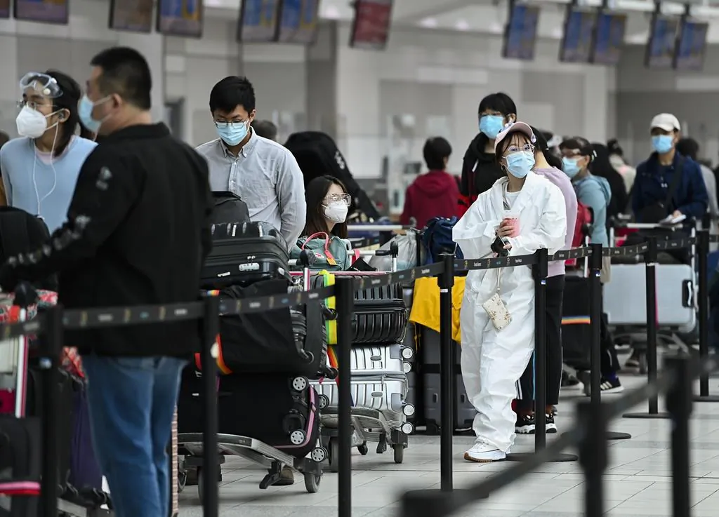 People line up and check in for an international flight at Pearson International airport during the COVID-19 pandemic in Toronto on Oct. 14, 2020. (The Canadian Press/Nathan Denette)