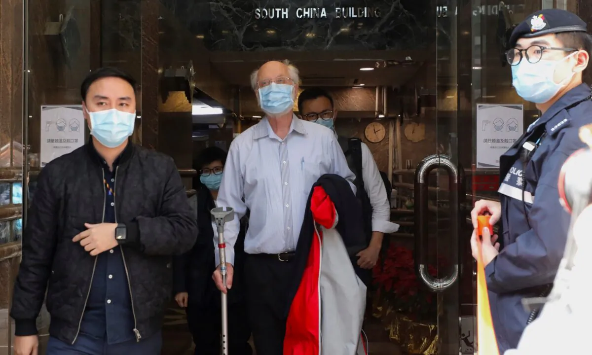 American human rights lawyer John Clancey, center, is arrested by police in Hong Kong, on Jan. 6, 2021. (Apple Daily/AP Photo)