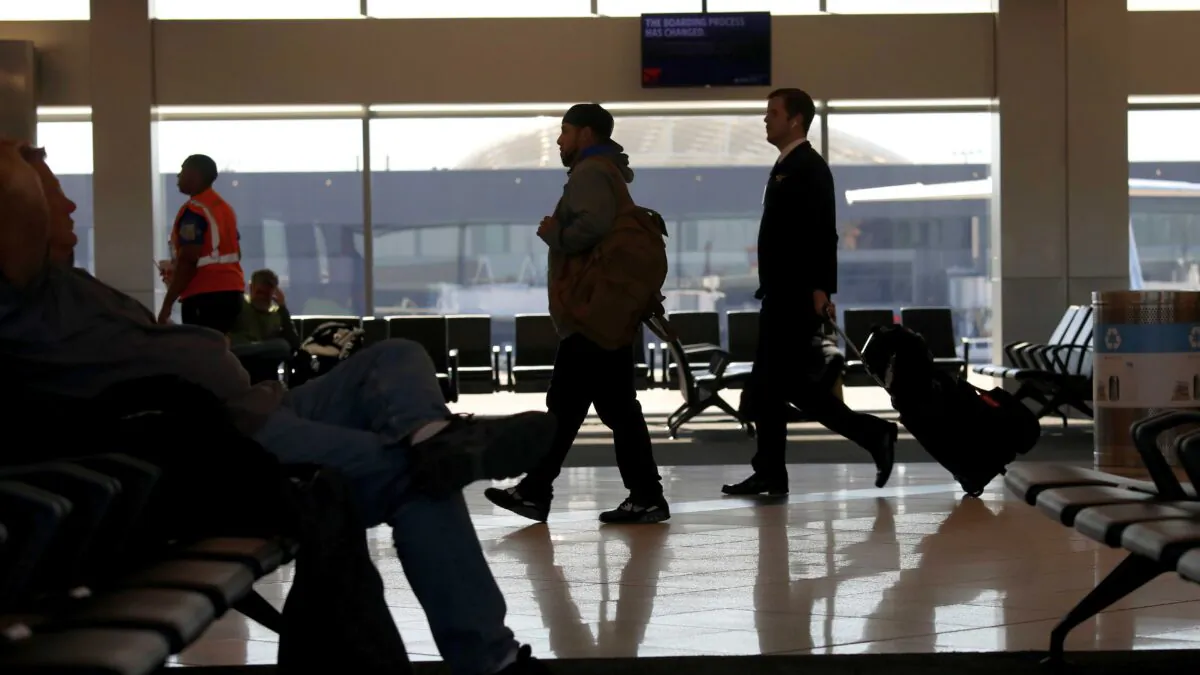 Travelers walk through terminal A at Hartsfield-Jackson Atlanta International Airport, in Atlanta, Ga., on April 20, 2020. (Rob Carr/Getty Images)