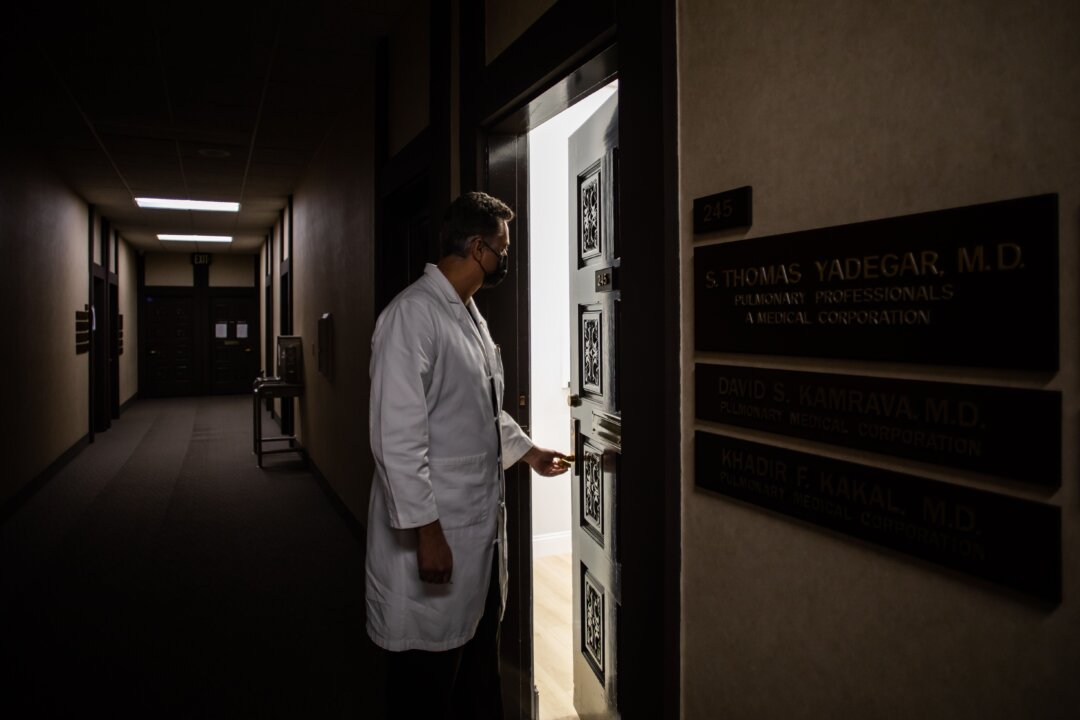 Medical Director of the Intensive Care Unit Dr. Thomas Yadegar works at night at his personal office in Tarzana, California after finishing his 12 hour shift at Providence Cedars-Sinai Tarzana Medical Center, on January 3, 2021. - (Photo by APU GOMES/AFP via Getty Images)