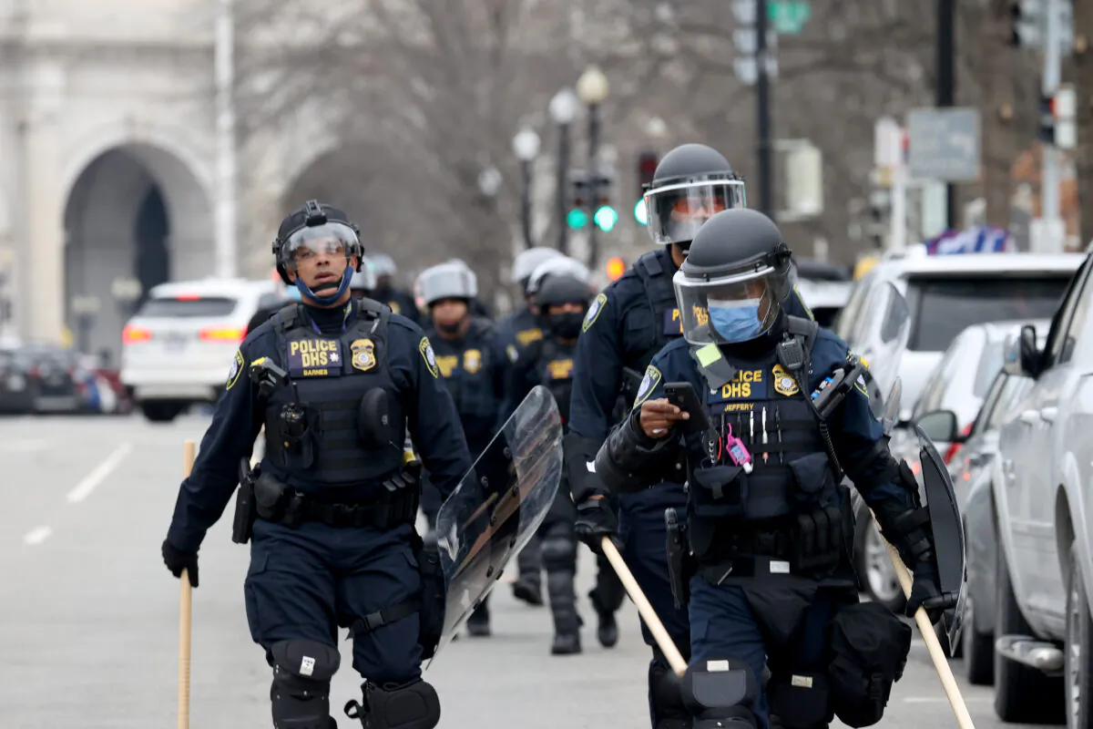 Police officers in riot gear walks towards the U.S. Capitol as a group protesters breached the Capitol building in Washington on Jan. 6, 2021. (Tasos Katopodis/Getty Images)