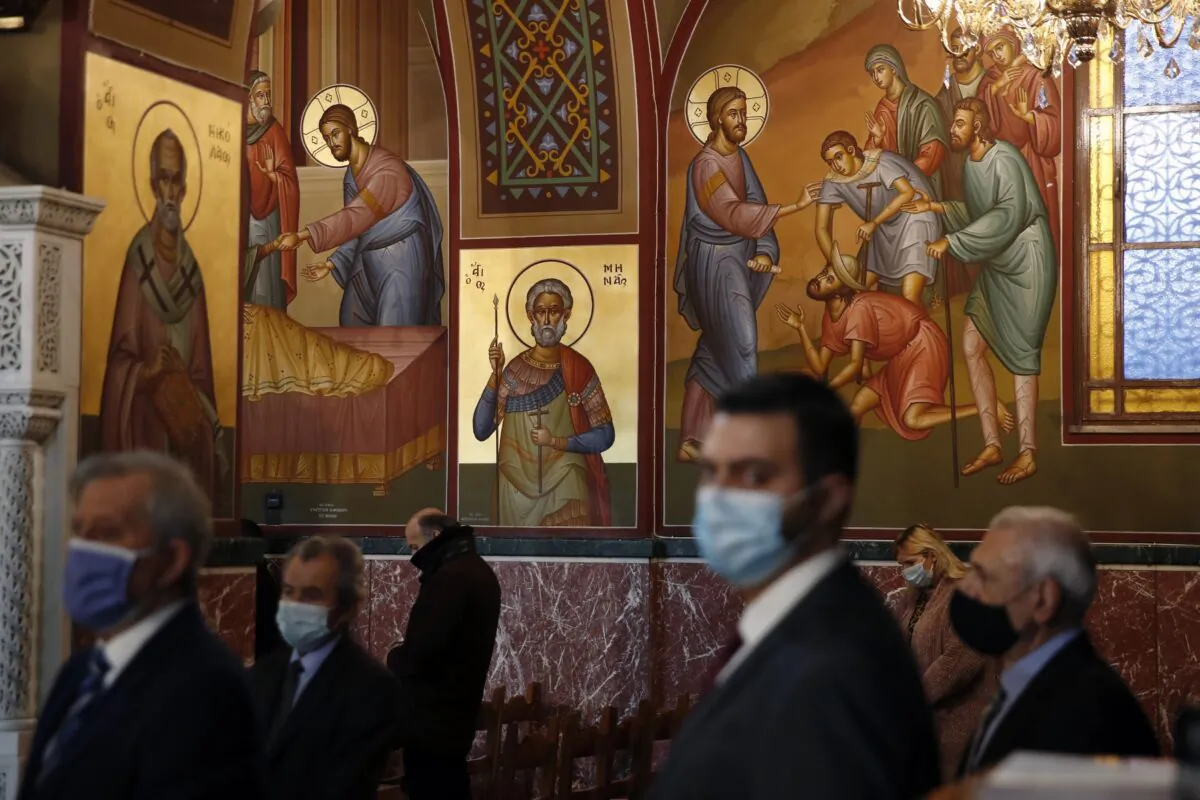 A limited congregation attends the service for the feast of the Epiphany in the Church of the Holy Trinity in Piraeus, the port of Athens, Greece, on Jan. 6, 2021. (Thanassis Stavrakis/AP Photo)