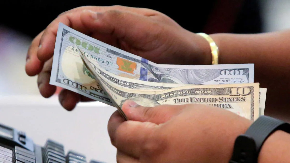 A cashier handles money in Macy’s Herald Square in Manhattan on Nov. 23, 2017. (Andrew Kelly/Reuters)