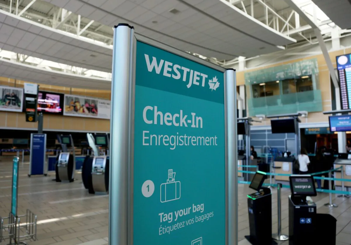 FILE PHOTO: WestJet airline signage is pictured at Vancouver's international airport in Richmond, British Columbia, Canada, February 5, 2019. (Reuters/Ben Nelms/File Photo)