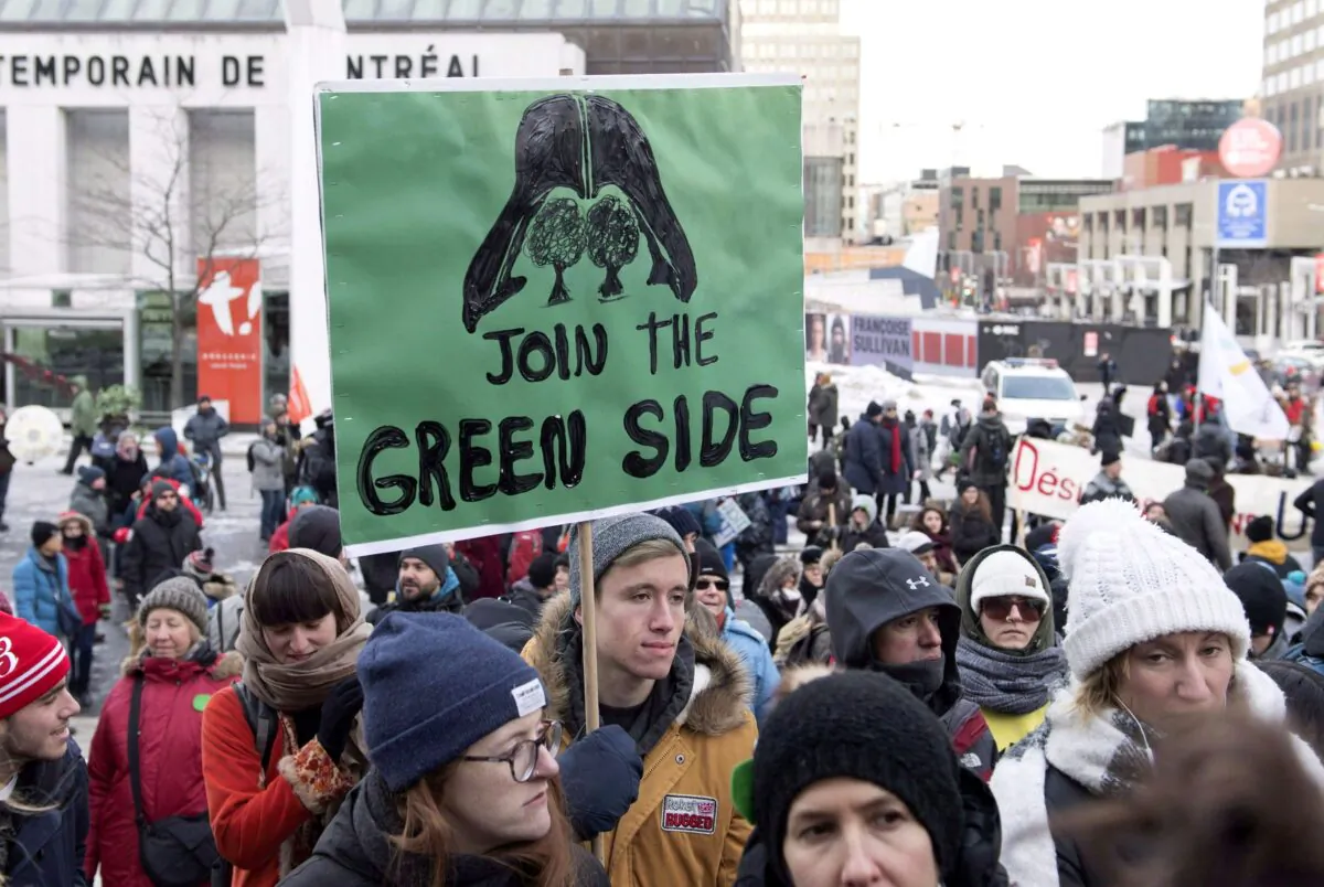 People attend a climate change demonstration in Montreal on Dec. 8, 2018. The mantra to build a “green economy” is actually code to kill the oil and natural gas industry replace it with solar and wind power, battery-powered cars, and the like. (The Canadian Press/Graham Hughes)