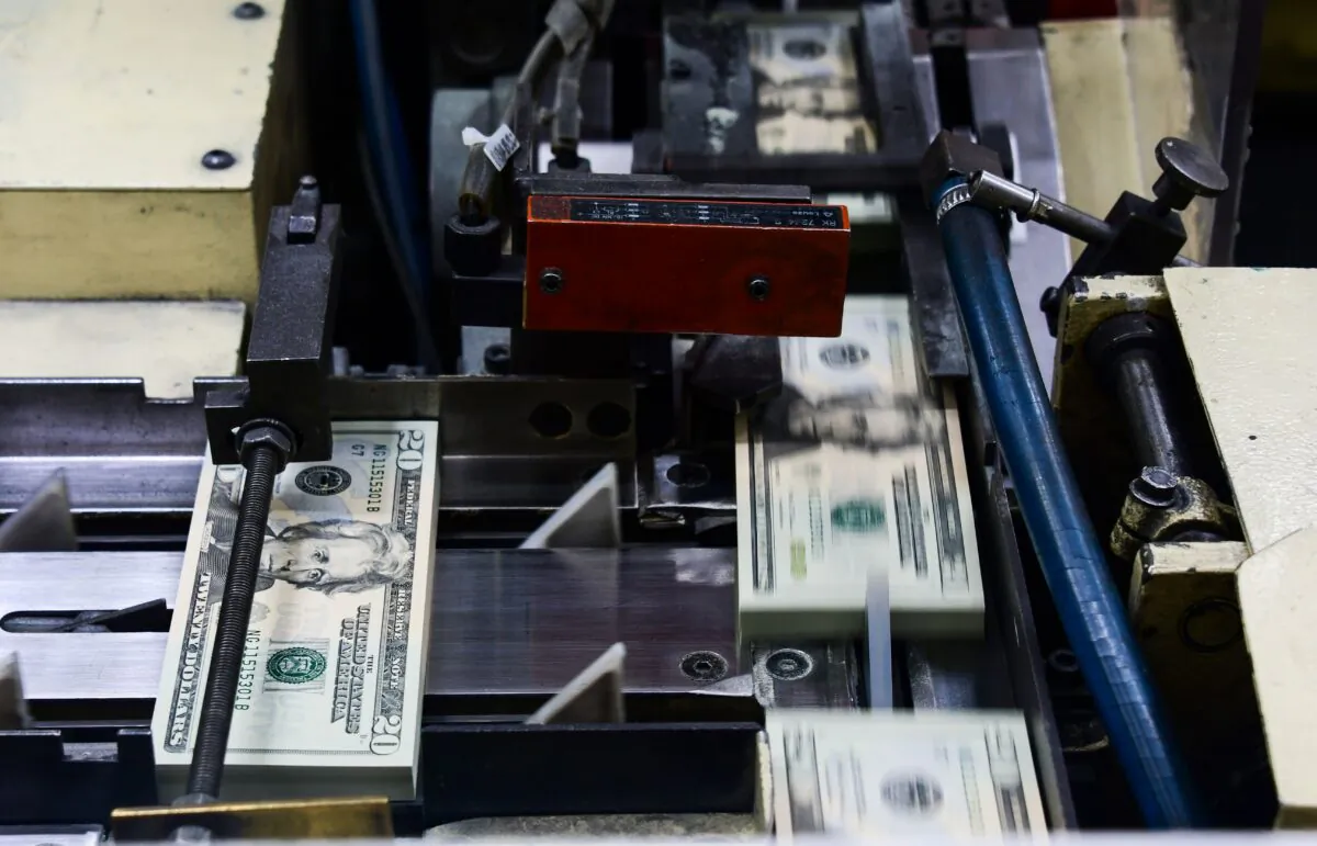 Packs of freshly printed $20 bills are processed for bundling at the U.S. Treasury's Bureau of Engraving and Printing in Washington on July 20, 2018. (Eva Hambach/AFP via Getty Images)