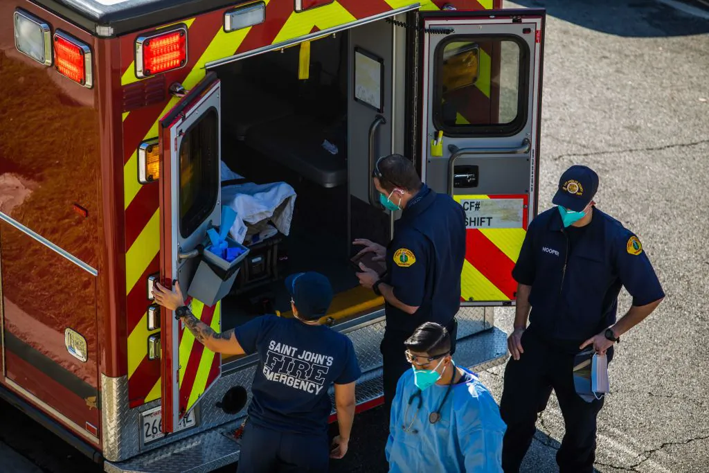 After administering him with oxygen, Los Angeles County paramedics load a potential Covid-19 patient in an ambulance before transporting him to a hospital in Hawthorne, Calif., on Dec. 29, 2020. (Photo by APU GOMES/AFP via Getty Images)
