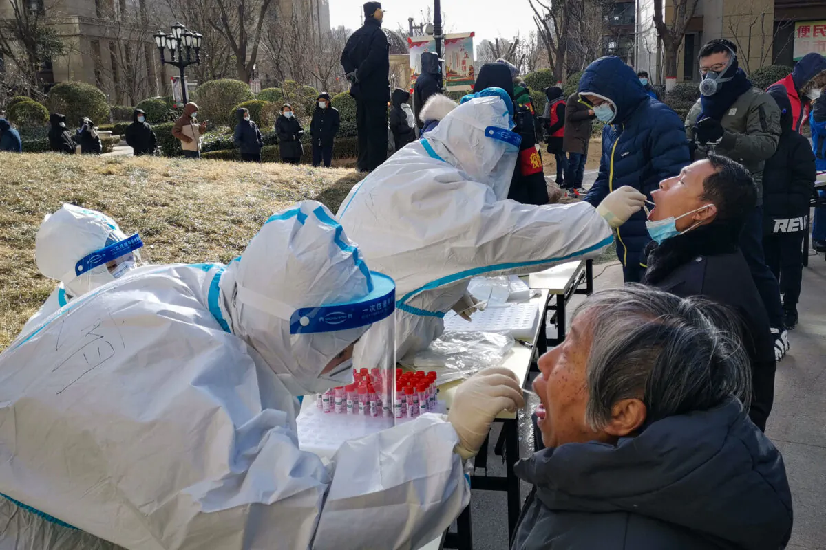Medical workers are taking swab samples from residents in Shijiazhuang city, Hebei Province, northern China, on Jan. 6, 2021. (STR/CNS/AFP via Getty Images)