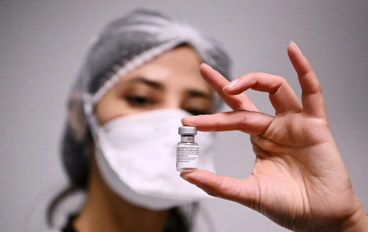 A health worker displays a dose of the Pfizer-BioNTech COVID-19 vaccine at Robert Ballanger hospita in Aulnay-sous-Bois, north of Paris, on Jan. 6, 2021. (Christophe Archambault/Pool Photo via AP)