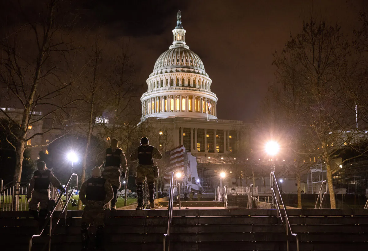 National Guard troops walk through the grounds of the U.S. Capitol in Washington, on Jan. 6, 2021. (John Moore/Getty Images)