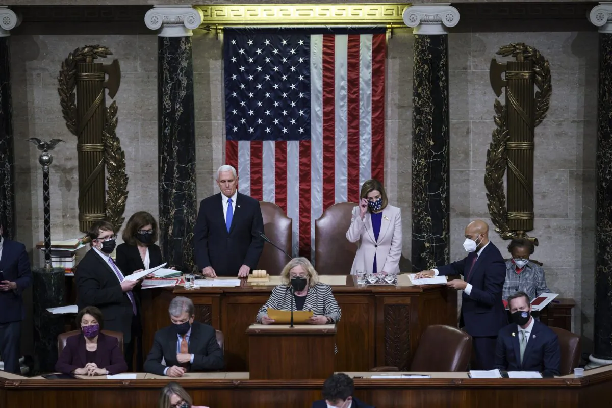Vice President Mike Pence and House Speaker Nancy Pelosi (D-Calif.) prepare to conclude a joint session of Congress, in Washington on Jan. 7, 2021. (J. Scott Applewhite/Pool/Getty Images)