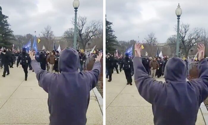 An unidentified individual waves protesters through open barricades into the Capitol grounds, as police stand back, in Washington on Jan. 6, 2021. (Screenshot of video by Unjungbits ONLY)