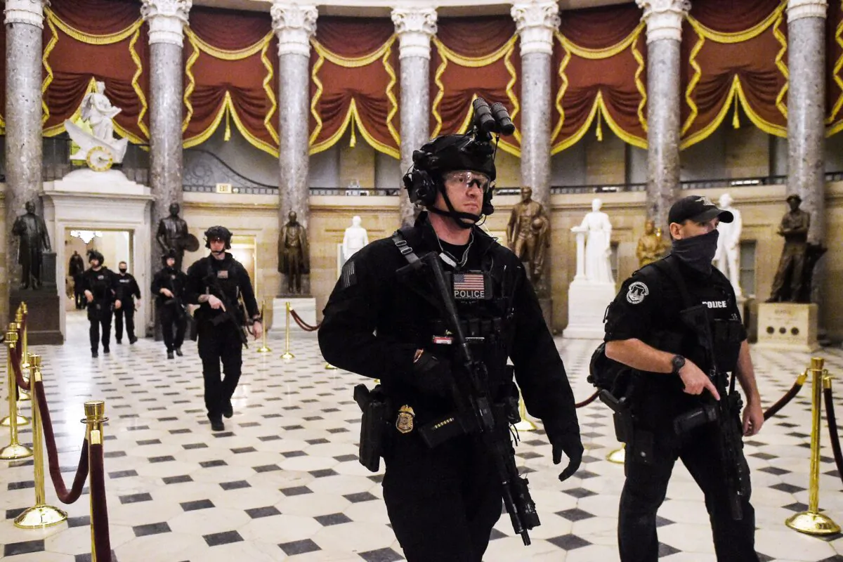 Members of the Swat team patrol and secure the Statuary Hall before Vice President Mike Pence makes his way into the House Chamber, at the US Capitol in Washington on Jan. 7, 2021. (Olivier Douliery/AFP via Getty Images)