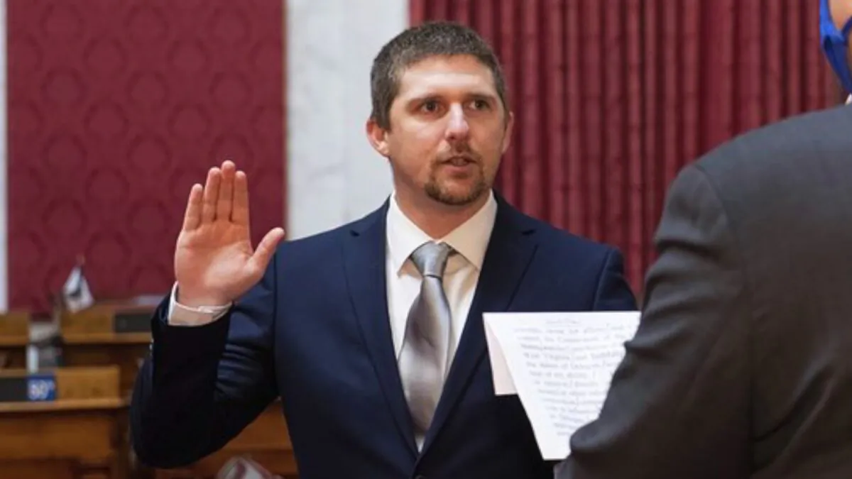 West Virginia House of Delegates member Derrick Evans is given the oath of office in the House chamber at the state Capitol in Charleston, W.Va., on Dec. 14, 2020. (Perry Bennett/West Virginia Legislature via AP)