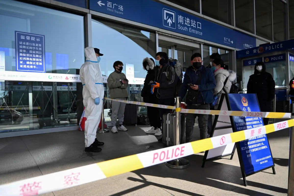 Passengers being stopped at the entrance of a railway station as the city cuts outside transport links and bans residents from leaving, after the large COVID-19 outbreak in Shijiazhuang, in northern China's Hebei Province on Jan. 7, 2021. (STR/CNS/AFP via Getty Images)