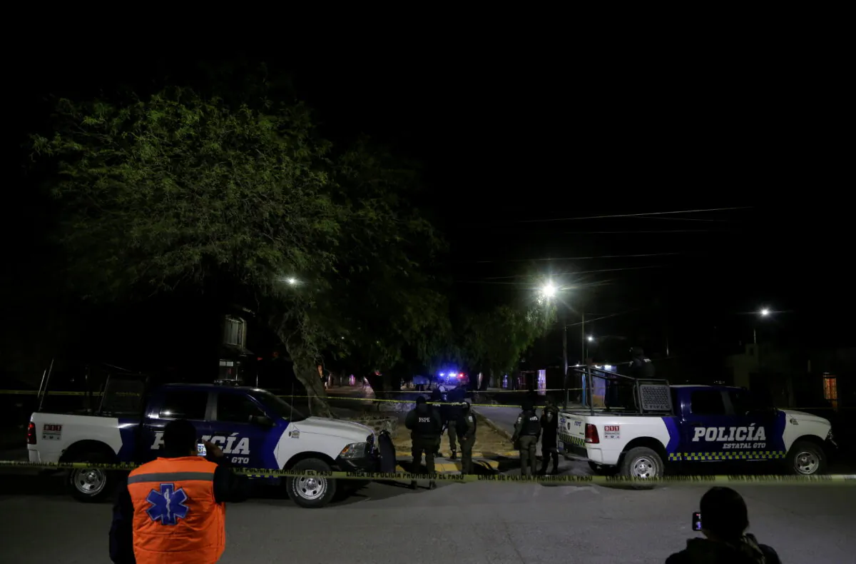 Police stand guard near a crime scene after unidentified gunmen burst into a wake killing several people, according to authorities, in Celaya, Mexico, on Jan. 7, 2021. (Sergio Maldonado/Reuters)