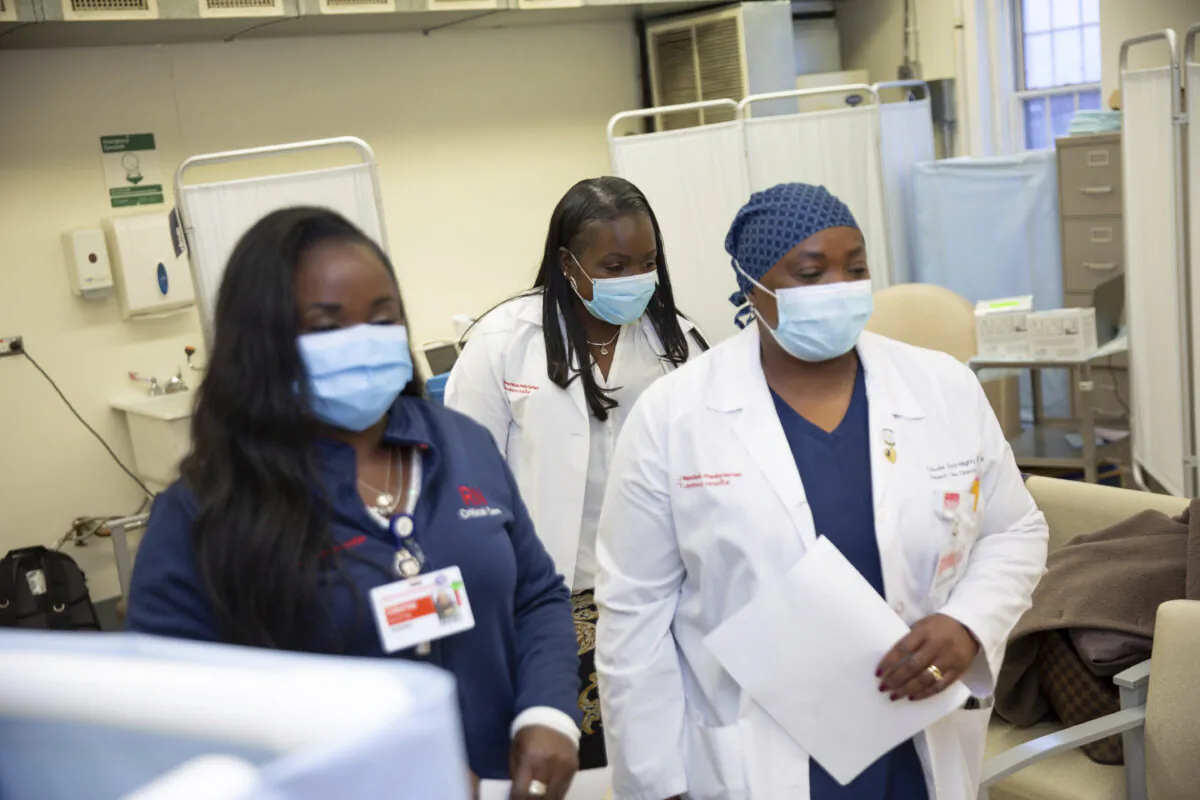 Christine Scott, an ICU nurse (L), with her sisters Althea Scott-Bonaparte and Claudia Scott-Mighty, who are patient care directors, arrived to get their second shot of the Pfizer vaccine at NewYork-Presbyterian Lawrence Hospital in Bronxville, N.Y., on Jan. 8, 2021. (Kevin Hagen/AP Photo).