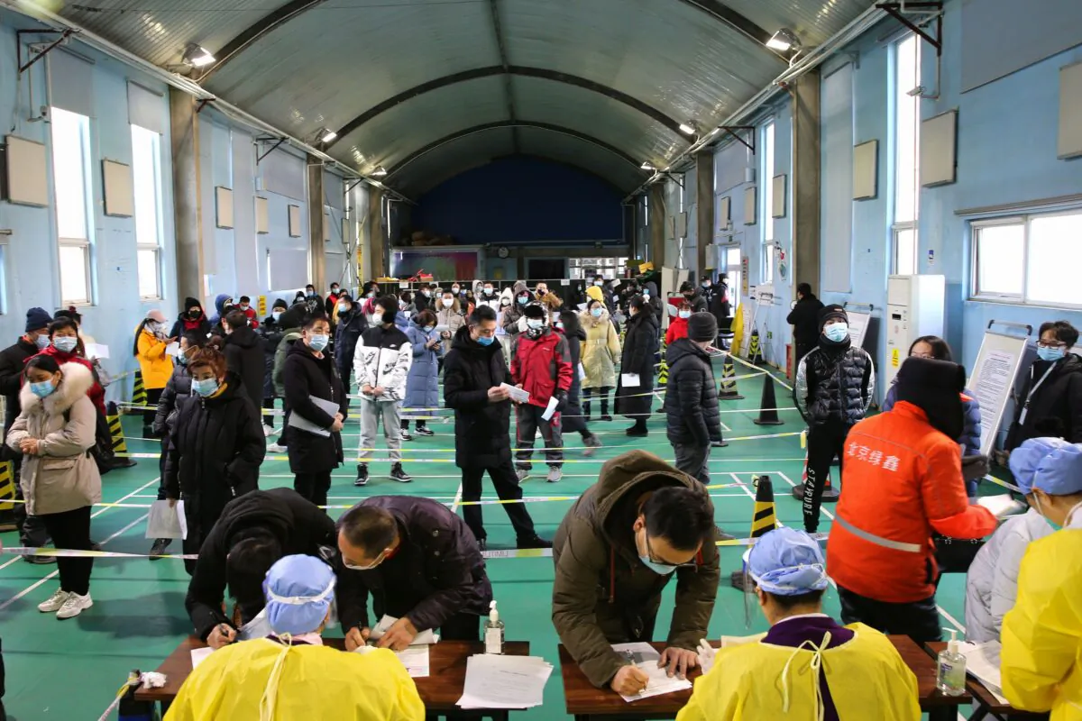People queue to receive the COVID-19 vaccine at a temporary vaccination center in Beijing on Jan. 8, 2021. (STR/CNS/AFP via Getty Images)