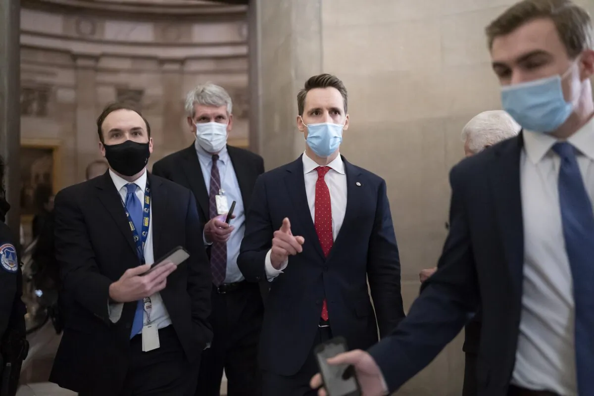 Sen. Josh Hawley (R-Mo.) walks to the House Chamber in Washington on Jan. 6, 2021. (Scott Applewhite/AP Photo)