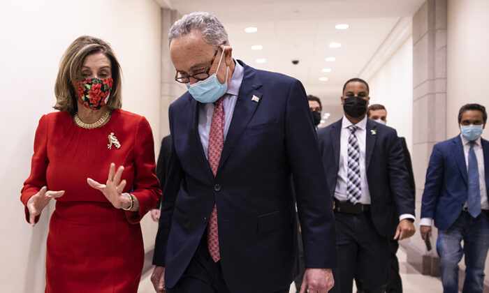 Speaker of the House Nancy Pelosi (D-Calif.) and Senate Minority Leader Chuck Schumer (D-N.Y.) speak after a press conference on Capitol Hill in Washington, on Dec. 20, 2020. (Tasos Katopodis/Getty Images)