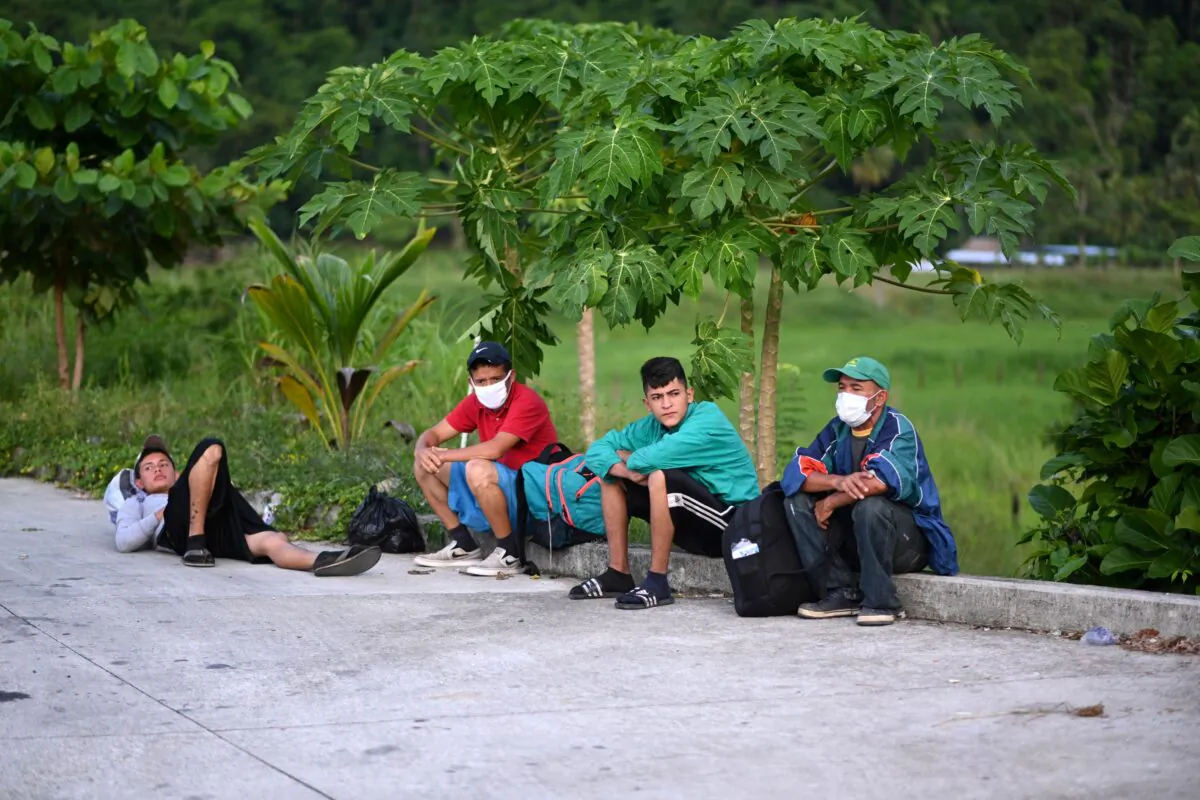 Honduran migrants, part of a U.S.-bound caravan, rest after being intercepted by Guatemalan Army members in San Luis, Peten department, Guatemala on Oct. 3, 2020. (Johan Ordonez/AFP via Getty Images)