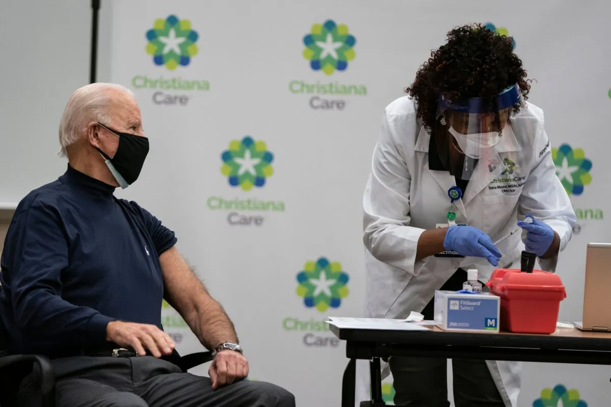 Then-President-elect Joe Biden watches as a nurse fills a syringe with a COVID-19 vaccine, at the Christiana Care campus in Newark, Del., on Dec. 21, 2020. (Alex Edelman/AFP via Getty Images)