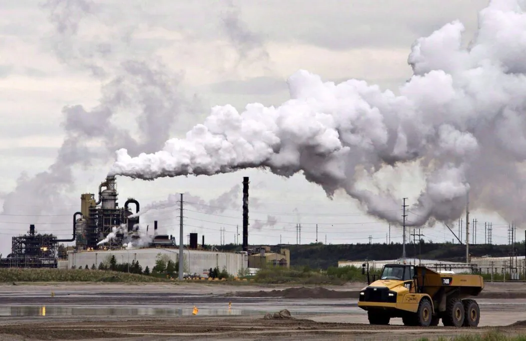 A dump truck works near the Syncrude oilsands extraction facility near Fort McMurray, Alta., in a file photo. (The Canadian Press/Jason Franson)