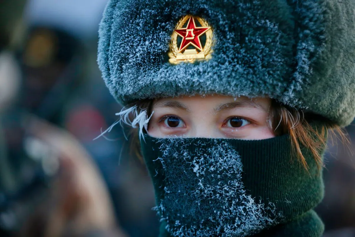 A female Chinese People's Liberation Army  soldier takes military training at Pamir Mountains in Kashgar, northwestern China's Xinjiang region on Jan. 4, 2021. (STR/AFP via Getty Images)