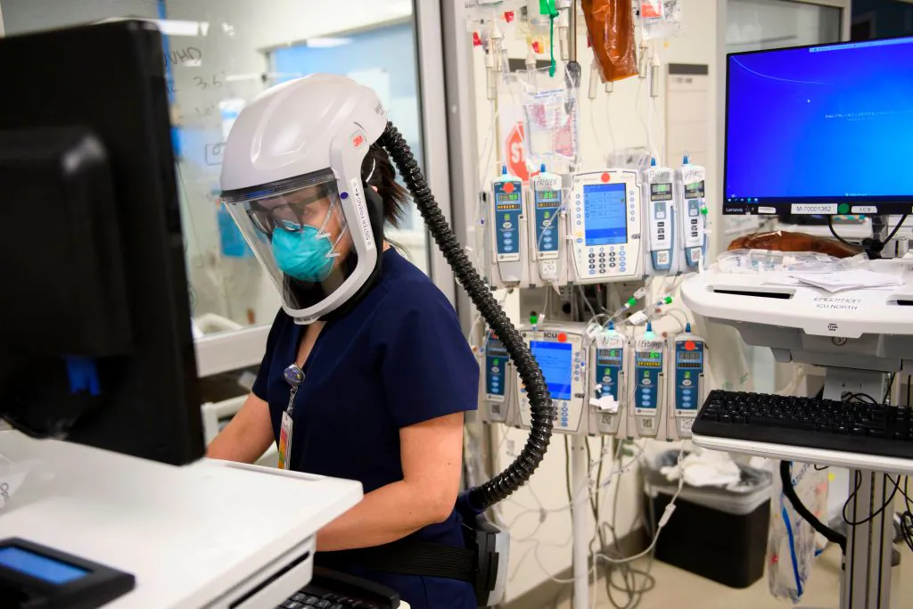 A nurse wearing personal protective equipment, including a personal air purifying respirator, works in a COVID-19 intensive care unit at Martin Luther King Jr. (MLK) Community Hospital on Jan. 6, 2021. (PATRICK T. FALLON/AFP via Getty Images)