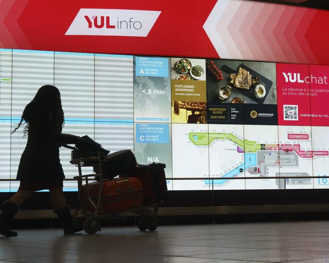 A passenger makes her way through Montreal Trudeau Airport in Montreal, on Jan. 7, 2021. Anyone applying for three federal benefits will now need to say whether they are in quarantine because they travelled outside the country. (The Canadian Press/Paul Chiasson)