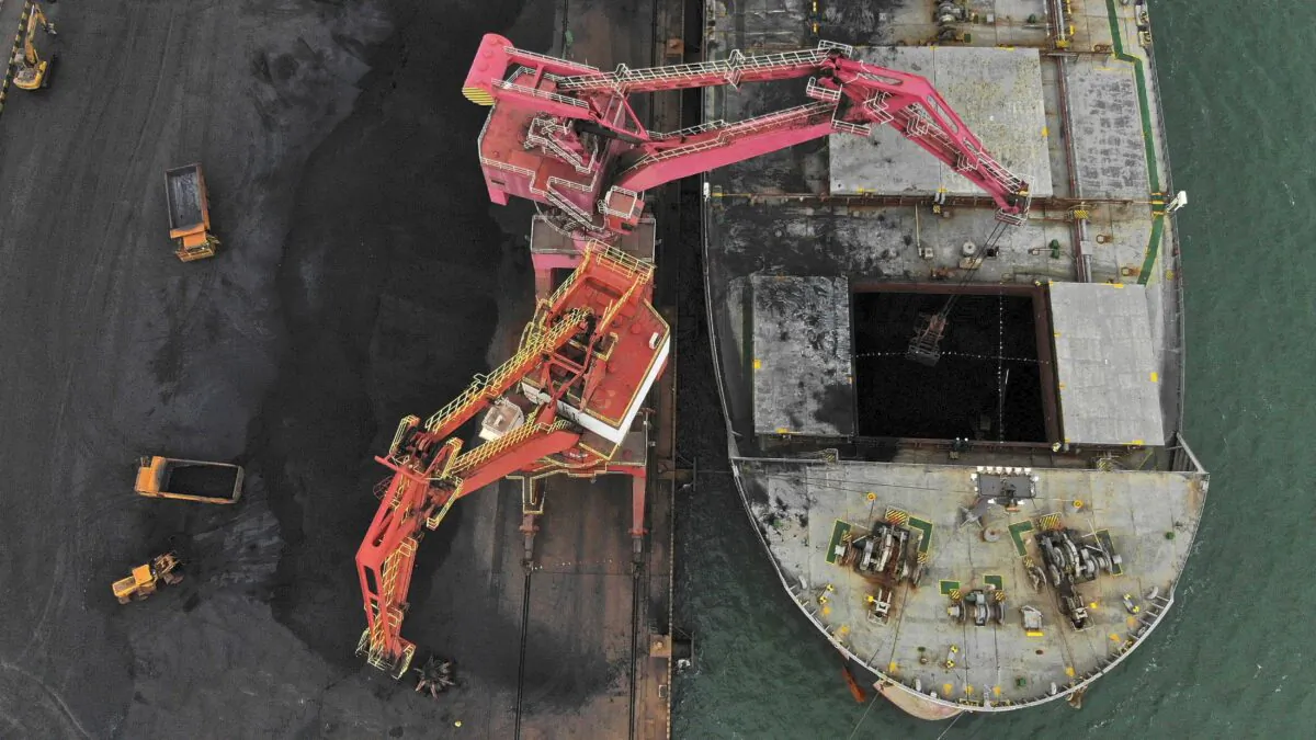 Machines load imported coal from a cargo vessel docked at a port in Rizhao in east China's Shandong Province on Nov. 21, 2019. (Wang Kai/Xinhua via AP)