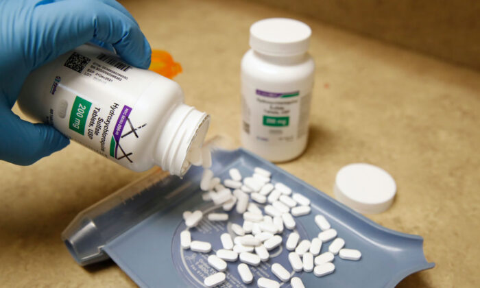 A pharmacy tech pours out pills of hydroxychloroquine at Rock Canyon Pharmacy in Provo, Utah, on May 20, 2020. (George Frey/AFP via Getty Images)