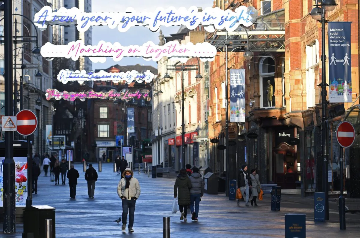 Pedestrians walk along an empty shopping street in Leeds, northern England, on Jan. 6, 2021, on the second day of Britain's national lockdown to combat the spread of COVID-19. (Oli Scarff /AFP via Getty Images)