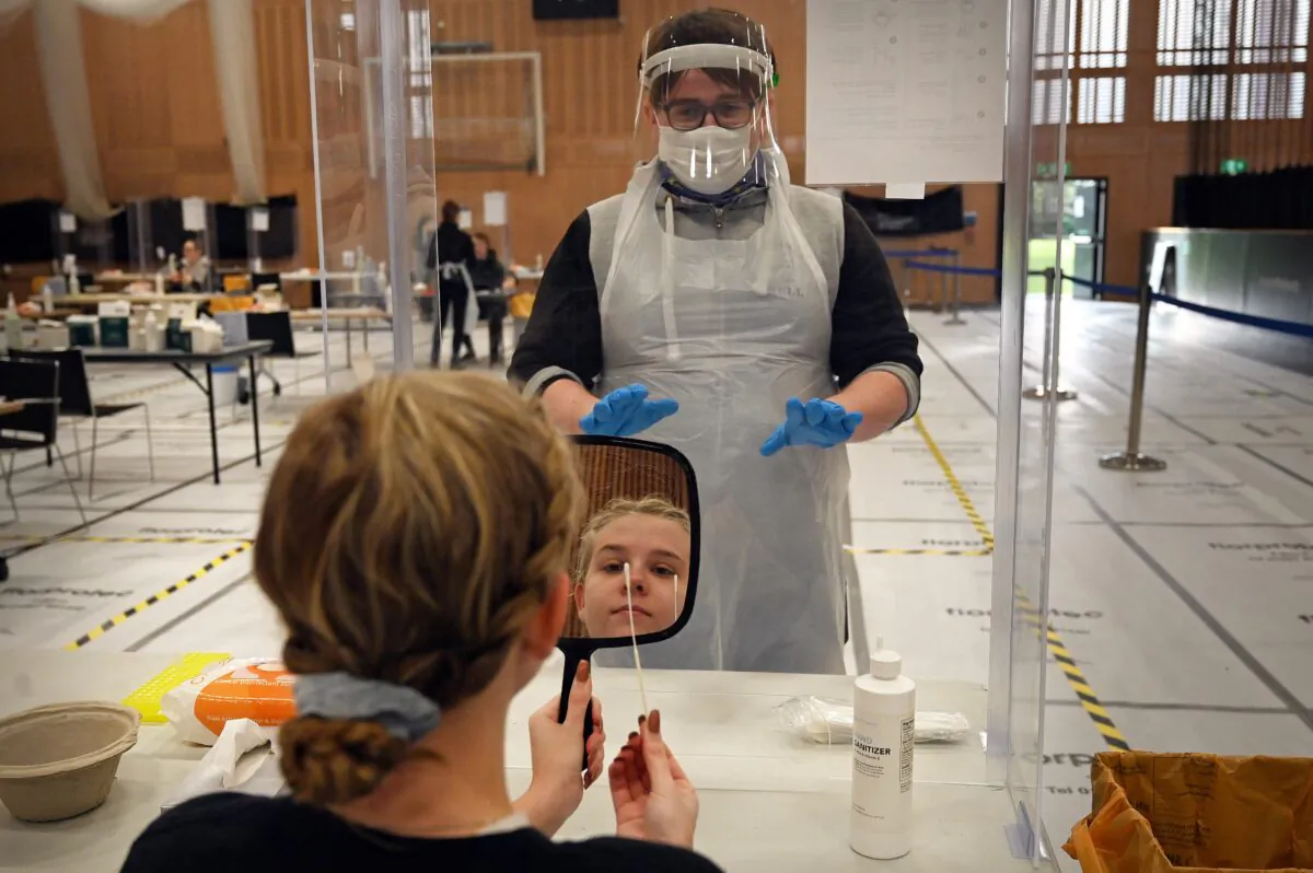 A  20-year-old  sports rehab student at Hull University, takes a swab for a lateral flow Covid-19 test at the campus sports facilities on Jan. 4, 2021. (Paul Ellis/AFP via Getty Images)